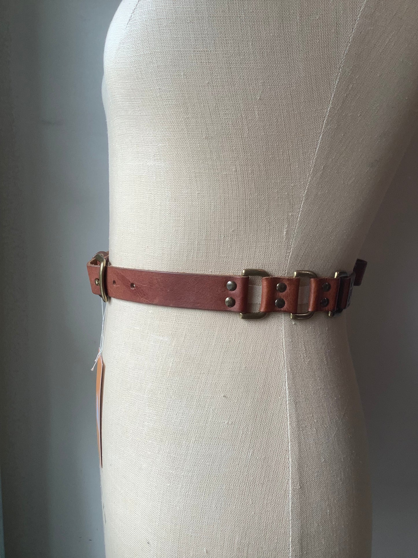 Brown leather and brass rivet belt