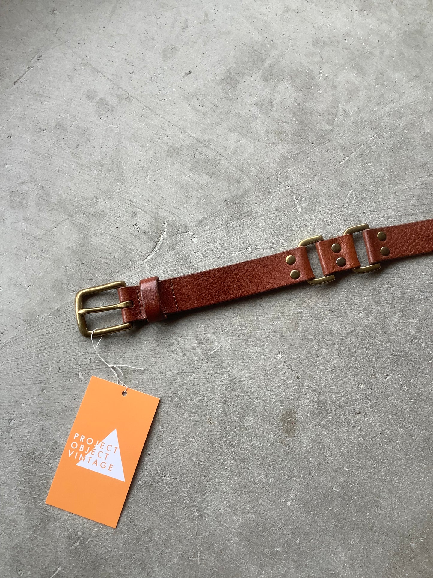 Brown leather and brass rivet belt