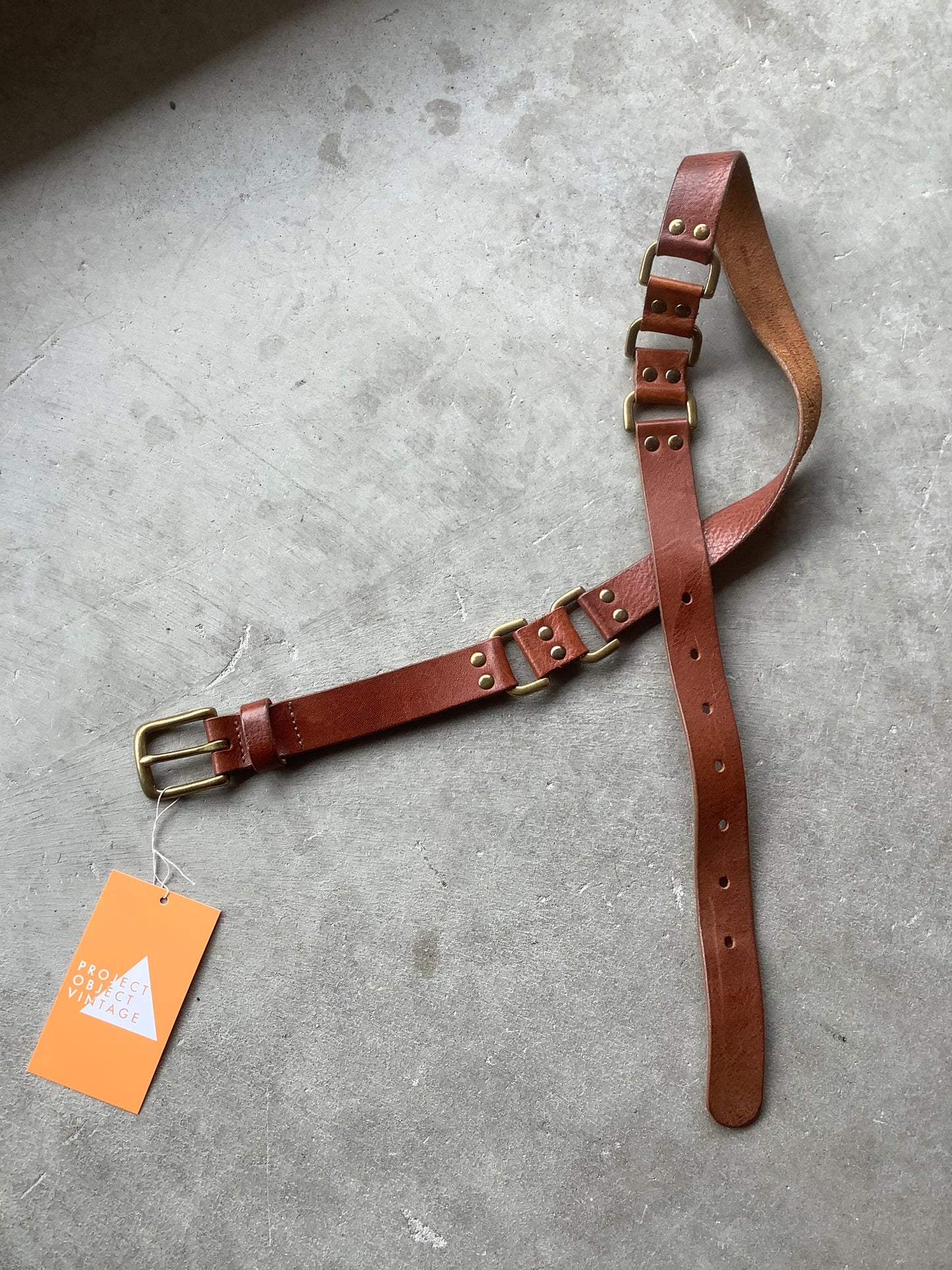 Brown leather and brass rivet belt
