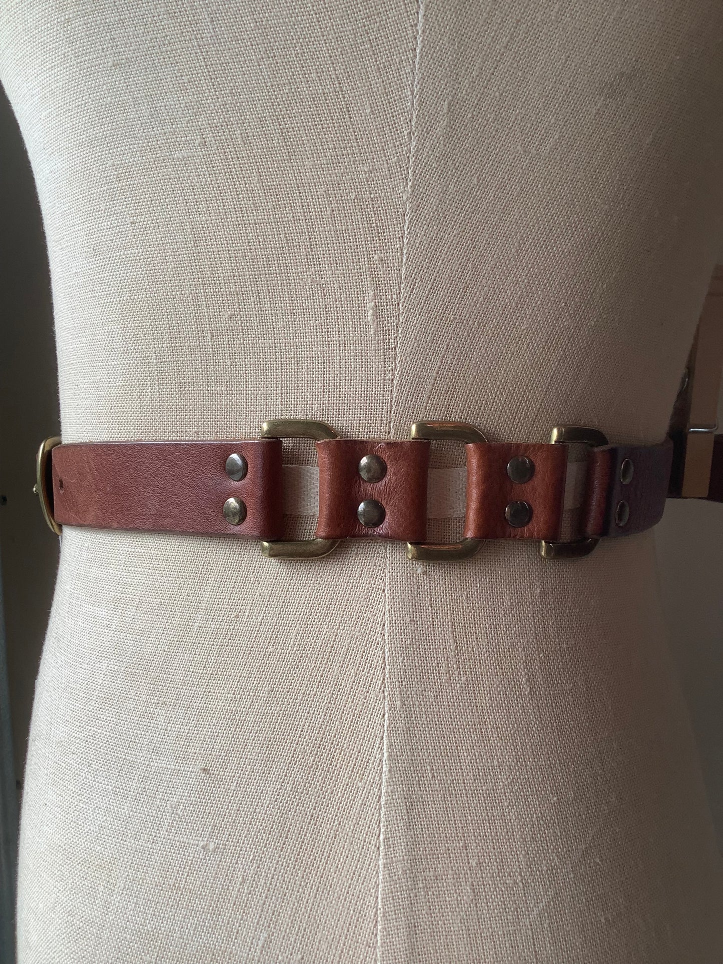 Brown leather and brass rivet belt